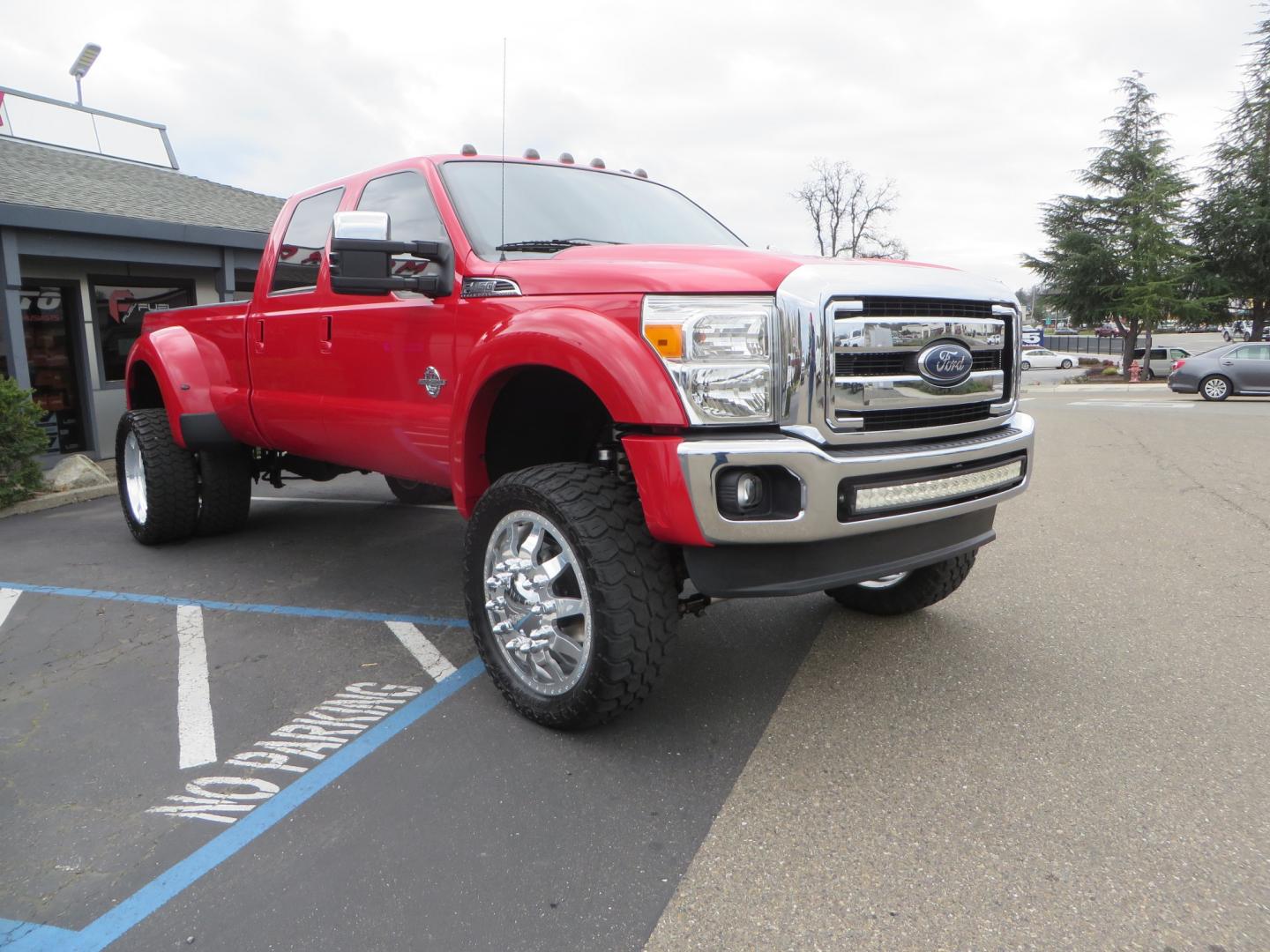 2014 Red /TAN Ford F450 Super Duty Crew Cab Lariat Crew Cab 4WD (1FT8W4DT7EE) with an V8 Turbo Diesel 6.7 Liter engine, Automatic 6-Spd w/SelectShift transmission, located at 2630 Grass Valley Highway, Auburn, CA, 95603, (530) 508-5100, 38.937893, -121.095482 - Wow!! 14 F450 sitting on Icon Vehicle Dynamics suspension, 24" American Force wheels, 37" tires, Rough Country back up leds, Light bar, Window tint, Smoked tail lights 3rd brake light, cab lights, and marker lights, Air bags with compressor, and train horns. Must see this head turner! - Photo#2